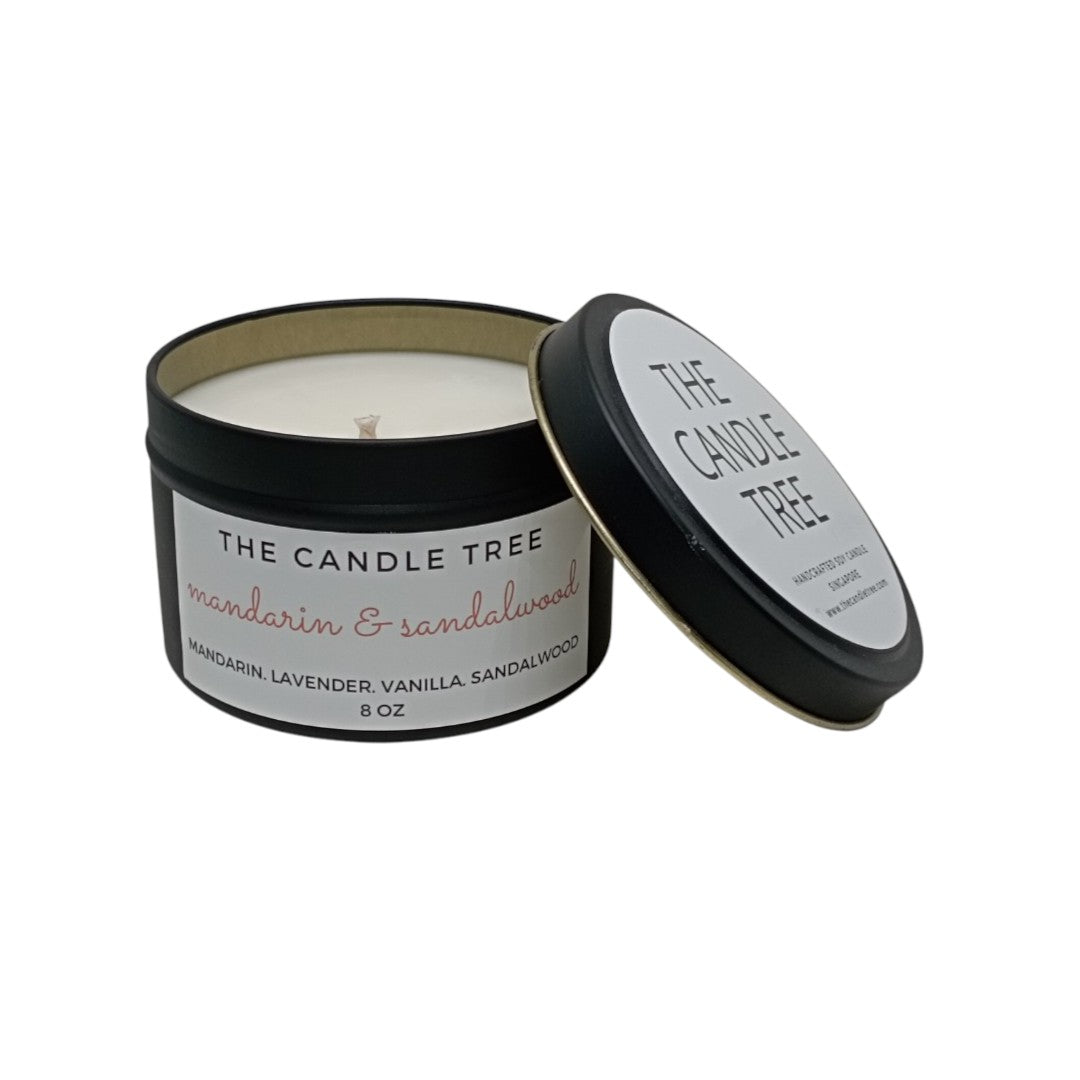 Candle in a black container featuring 'The Candle Tree' branding with a white background, scented 'Mandarin & Sandalwood.' Size 8oz
