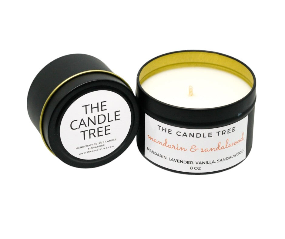 Candle in a black container featuring 'The Candle Tree' branding with a white background, scented 'Mandarin & Sandalwood.' Sizes 4 and 8oz